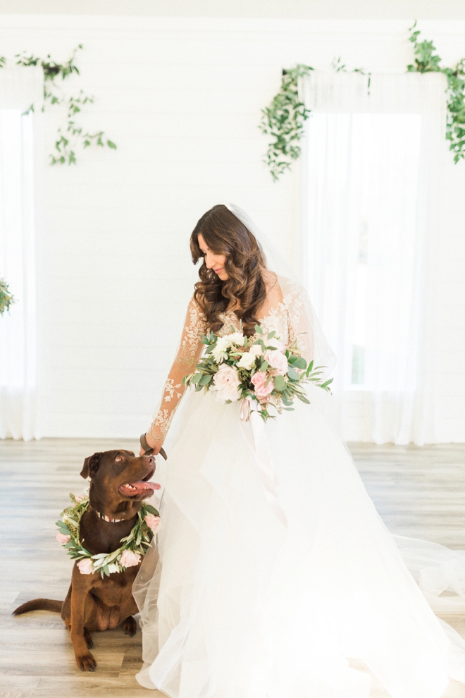 Stunning bride with her pup wearing a flower necklace!