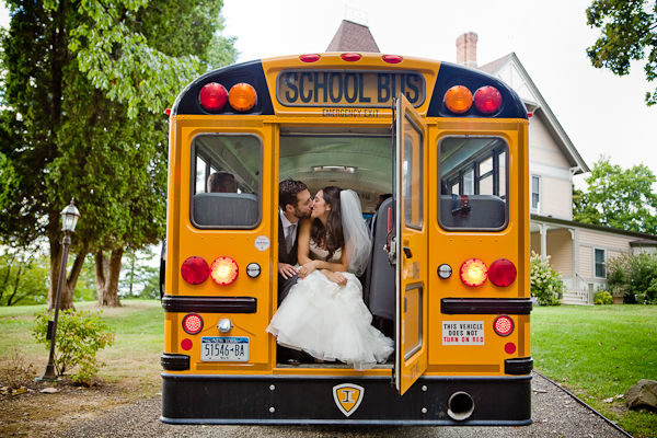 Adorable bride and groom kissing in the back of a school bus!