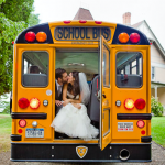 Adorable bride and groom kissing in the back of a school bus!