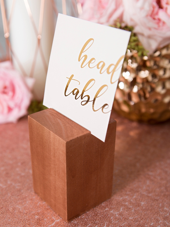 Create your own wood block table number stands and paint them any color!