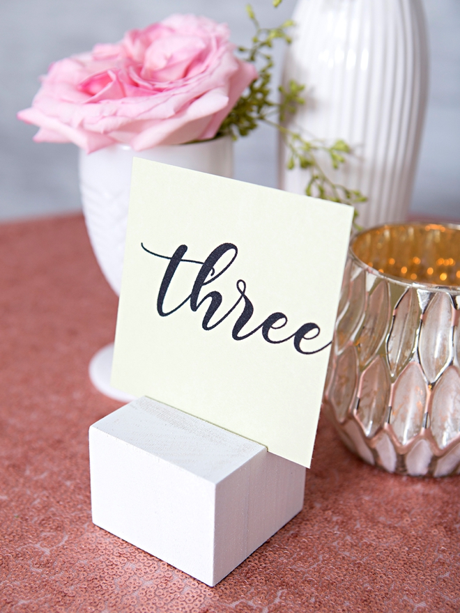 Create your own wood block table number stands and paint them any color!