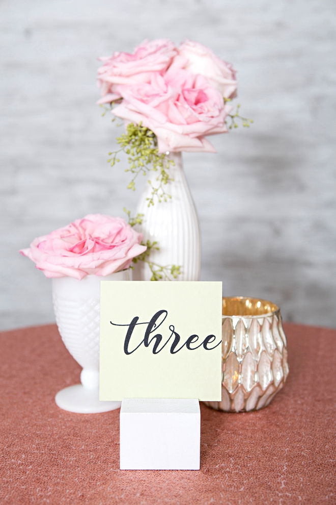 Create your own wood block table number stands and paint them any color!