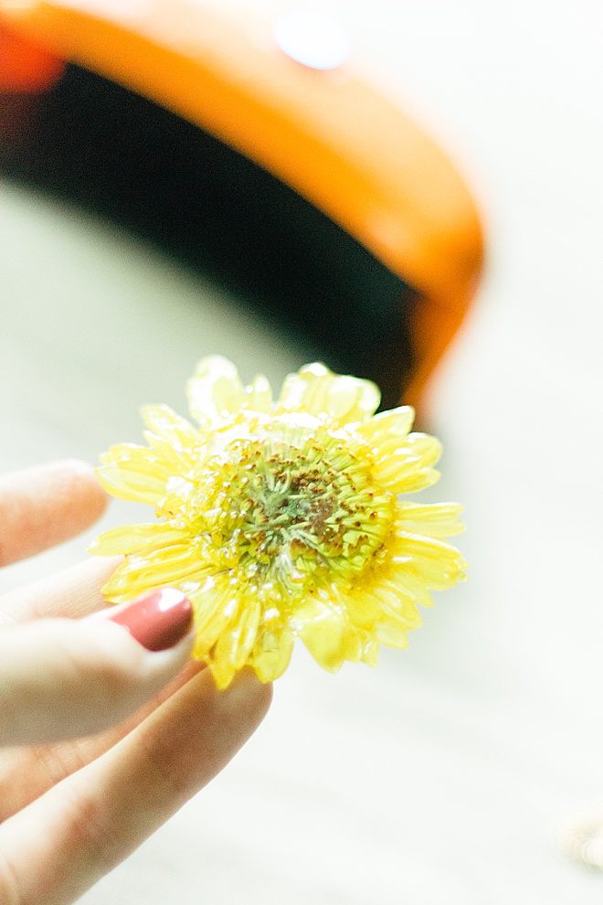 Preserve your wedding flowers with this simple resin pressed flower DIY!