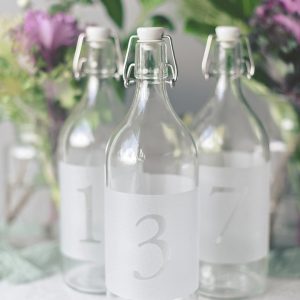 Frosted carafe glass bottles for wedding table numbers