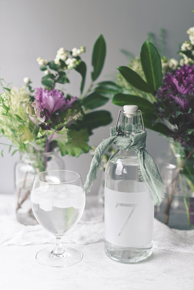 Beautifully simple glass carafe wedding table numbers with frosted window cling