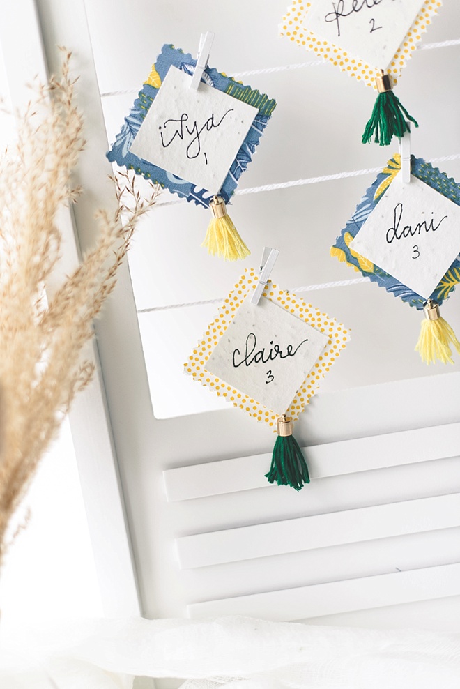 Fabric wedding place cards with mini scrapbook tassels